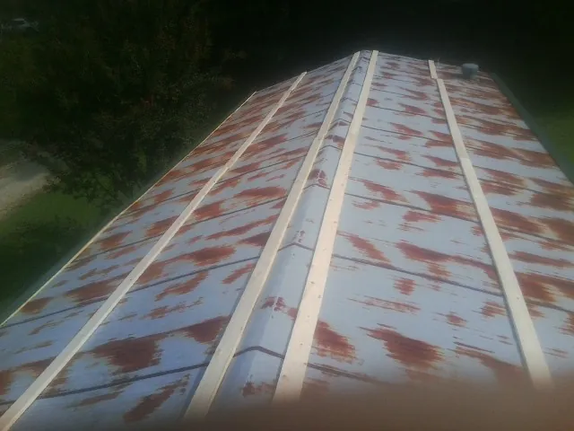 Rusted metal roof panels with new wood purlins before replacement — Storm Damage Roof Repair in Emmaus by Roofing Brothers