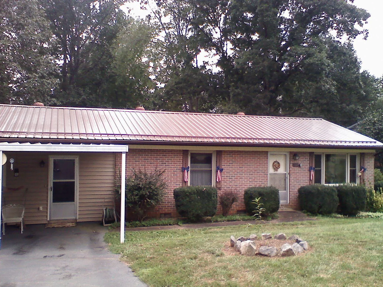 Bronze metal roof and carport on a brick ranch home — Roof Repair work by our crew in Emmaus