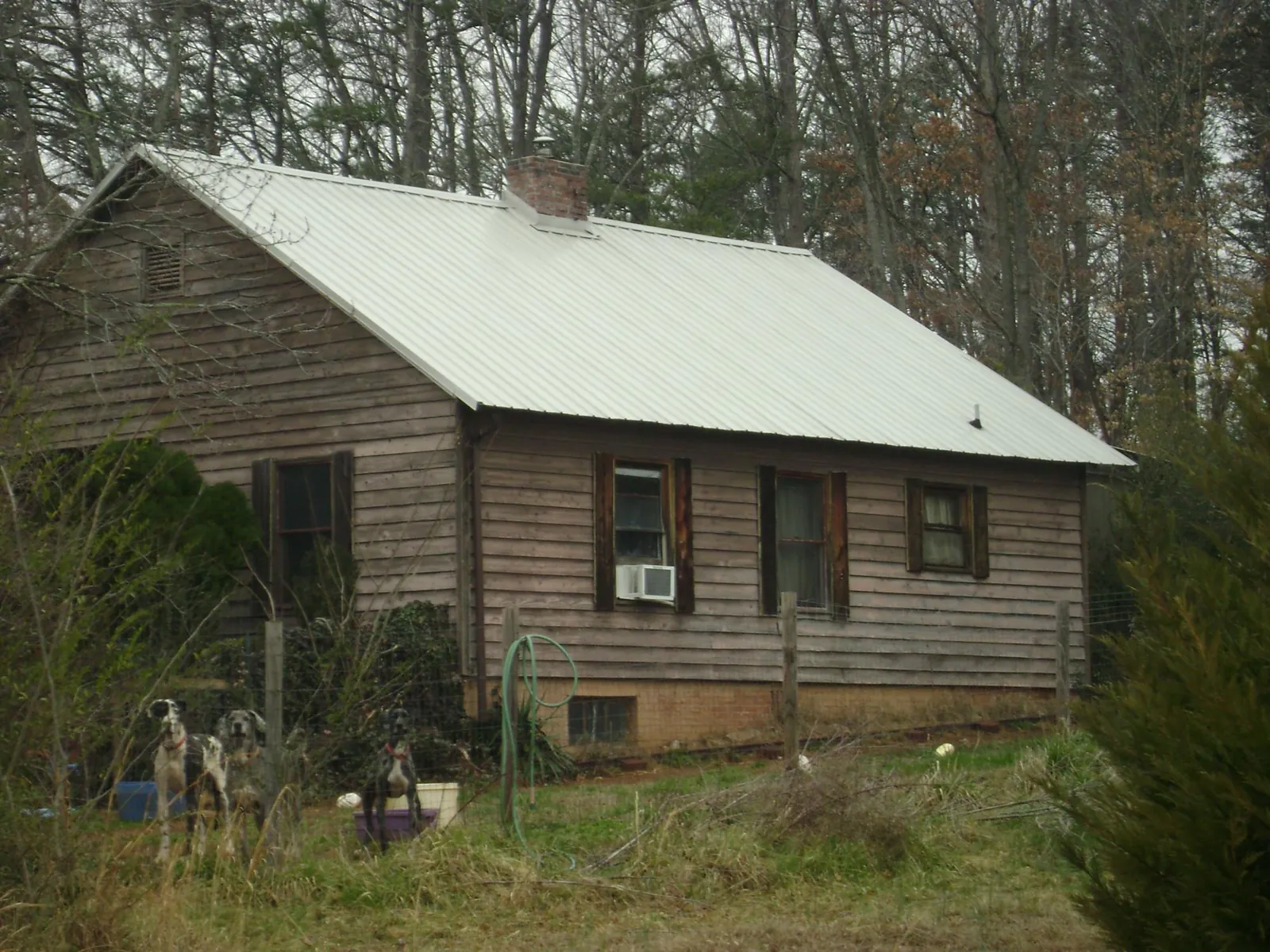 White metal roof on an old wood sided farmhouse, from a Metal Roof Installation job in Emmaus